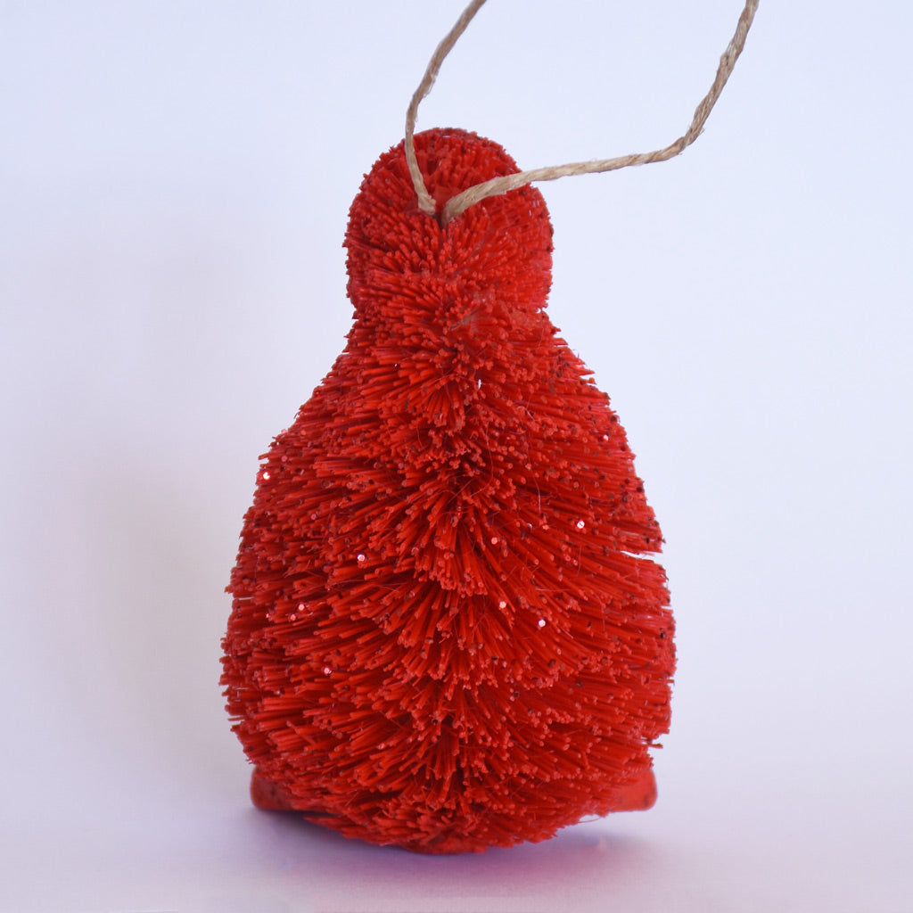 Decorative Bristle Kiwi bird ornament with glittery red finish on a white background