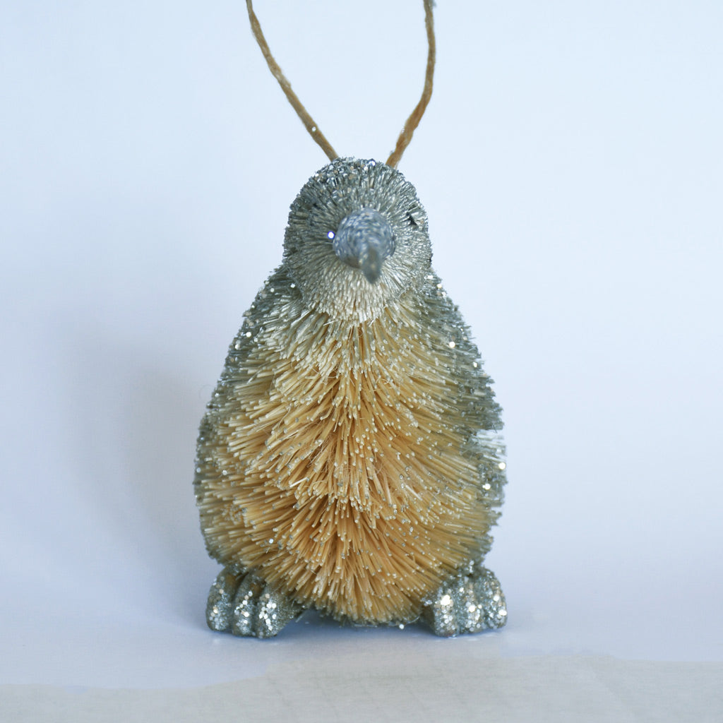 Decorative Bristle Kiwi bird ornament with glittery finish on a white background