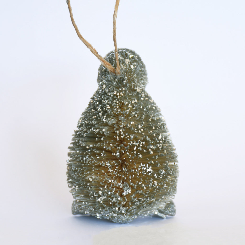 Decorative Bristle Kiwi bird ornament with glittery finish on a white background