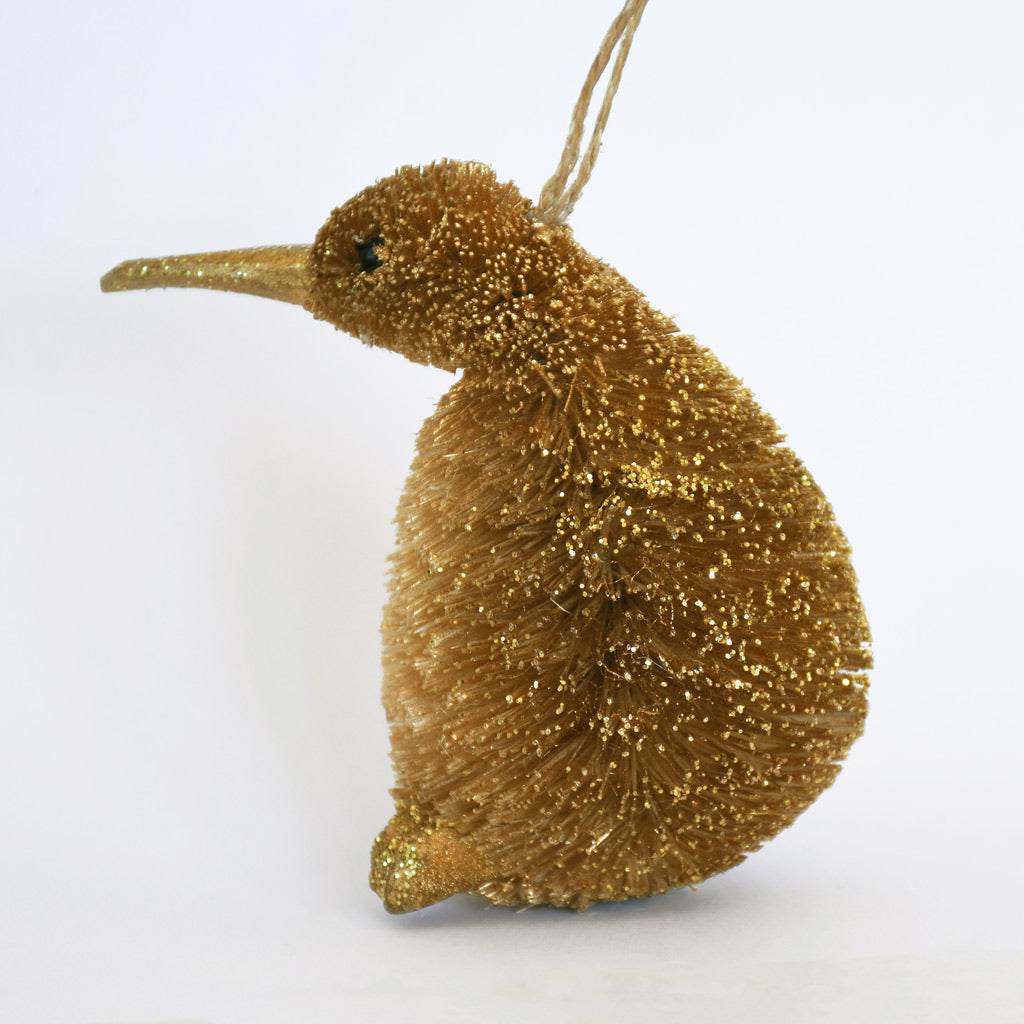 Decorative Bristle Kiwi bird ornament with glittery gold finish on a white background
