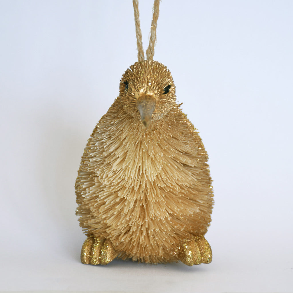 Decorative Bristle Kiwi bird ornament with glittery gold finish on a white background