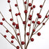 Close-up of artificial red berry branches on a white background